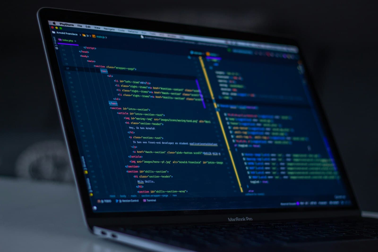 Two engineers reviewing code together on a laptop