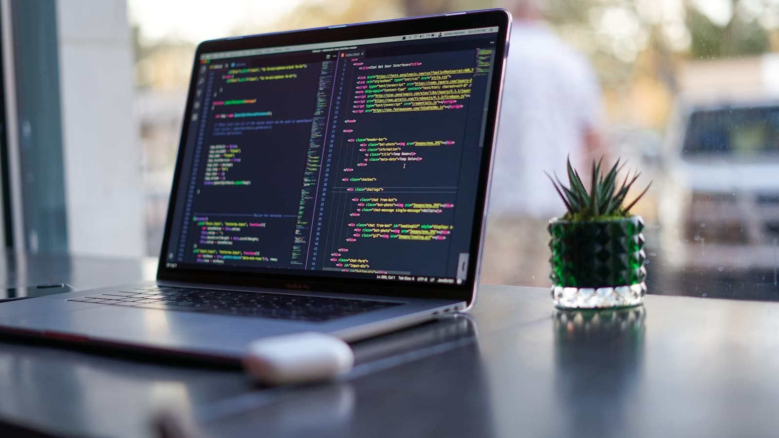 A developer's desk with code across two screens